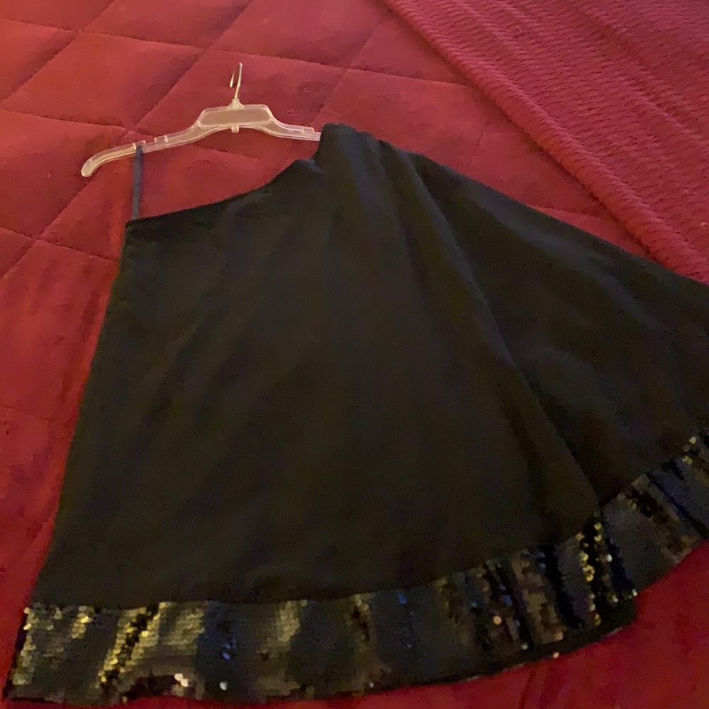 Elegant one shoulder top w shimmer trim.